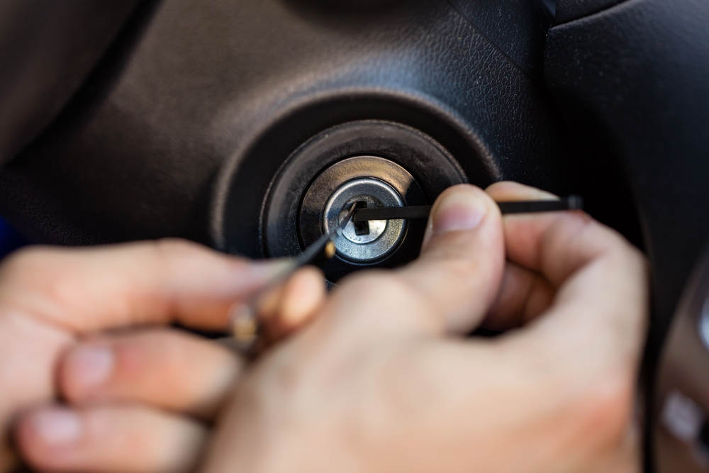 Auto locksmith cutting a car key
